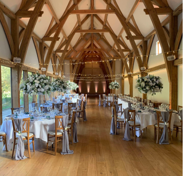 Elegant wedding ceremony styling with floral arch and aisle décor by The Wedding House in Worcestershire