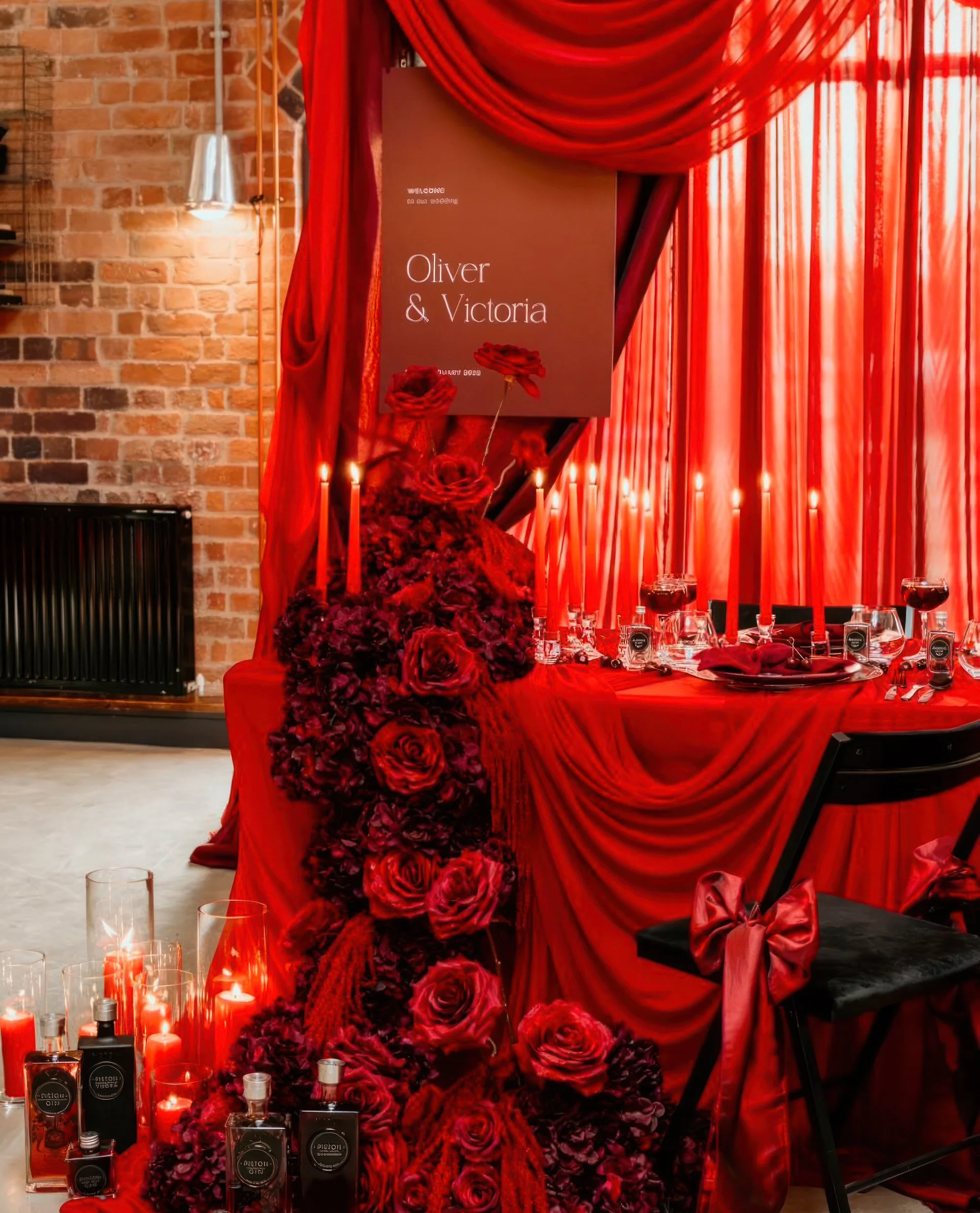 Red rose floral pillar with candles and wedding table decorations at Piston Distillery, wedding decor hire Worcestershire