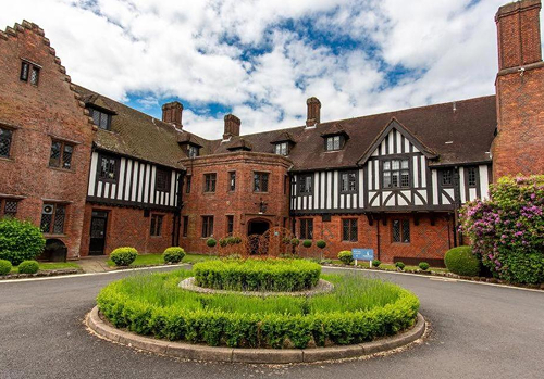 Hogarths Stone Manor wedding venue exterior with Tudor style architecture and landscaped entrance in Worcestershire