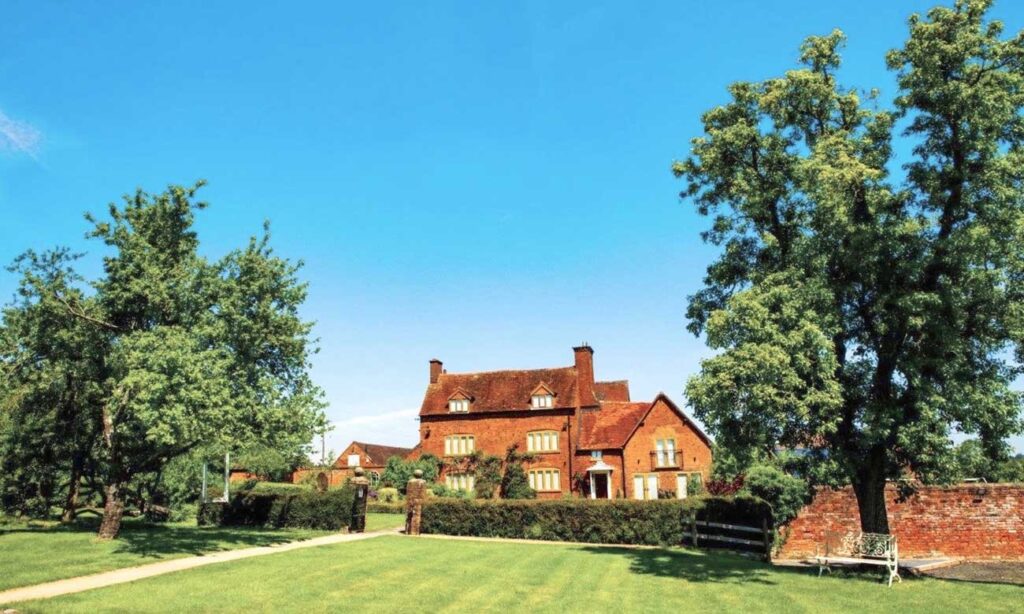 Bordesley Park wedding venue exterior with red brick house, gardens and countryside in Worcestershire