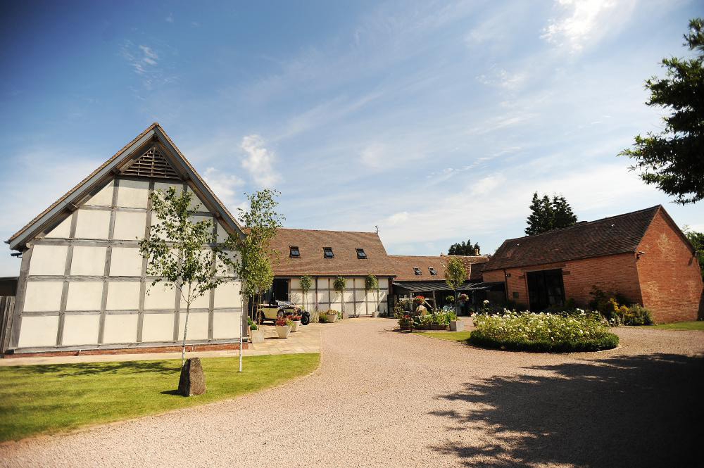 Redhouse Barn wedding venue exterior with barn buildings, courtyard and countryside setting in Worcestershire