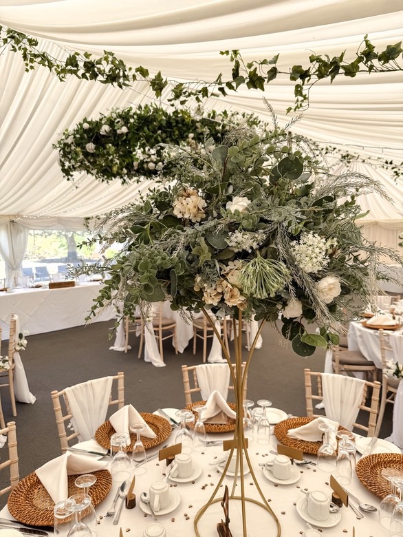 Tall greenery wedding centrepiece with eucalyptus and neutral table styling in marquee at Grafton Manor wedding decor hire Worcestershire
