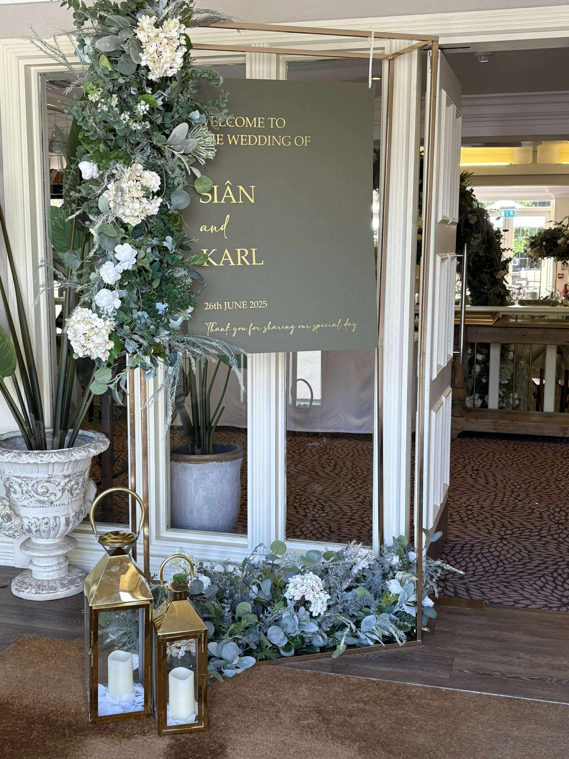 Hogarths Stone Manor wedding welcome sign with sage green board, floral decor, lanterns and elegant entrance styling