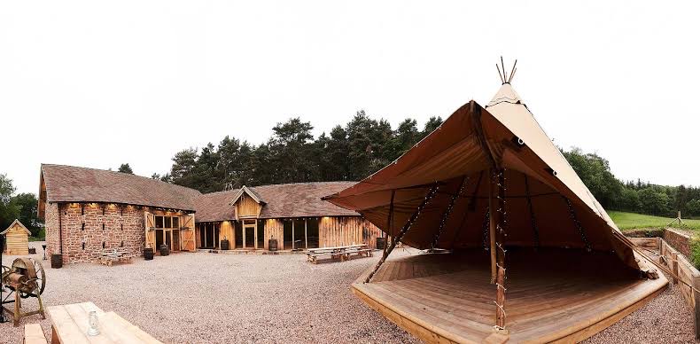 tipi wedding setup at Bridal Barn Shropshire with rustic courtyard and barn buildings